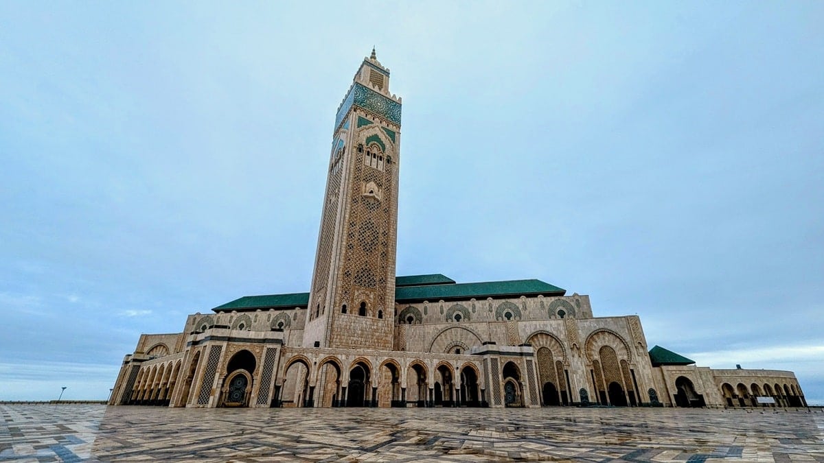 Hassan II Mosque in Morocco with its tiled entrance, spire and green roof