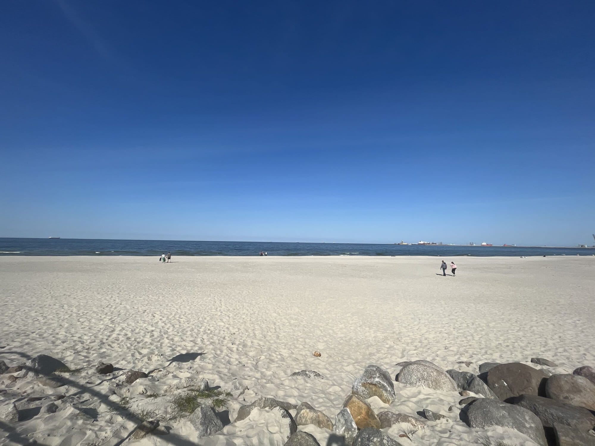 Brzenzo Beach in Gdansk with white and at the forefront and then blue ocean