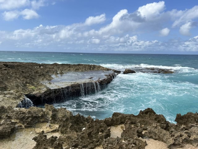 rocky beach with a shelf hanging over the ocean