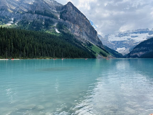 lake in front of grey mountains on a cloudy day