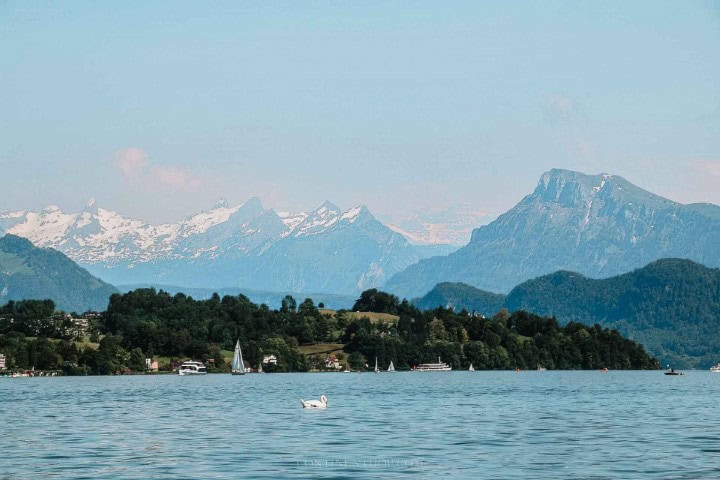 a lake with snowcapped mountains in the background in switzerland