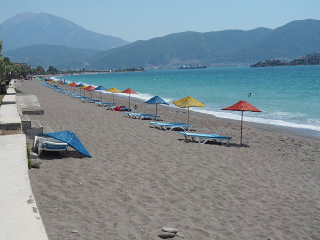 a row of colourful beach umbrellas on the beach