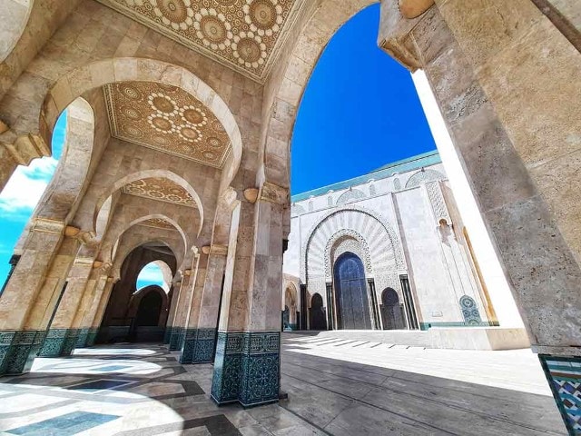 beautiful cream archways in Hassan ii Mosque, Casablanca with blue sky peeking out between