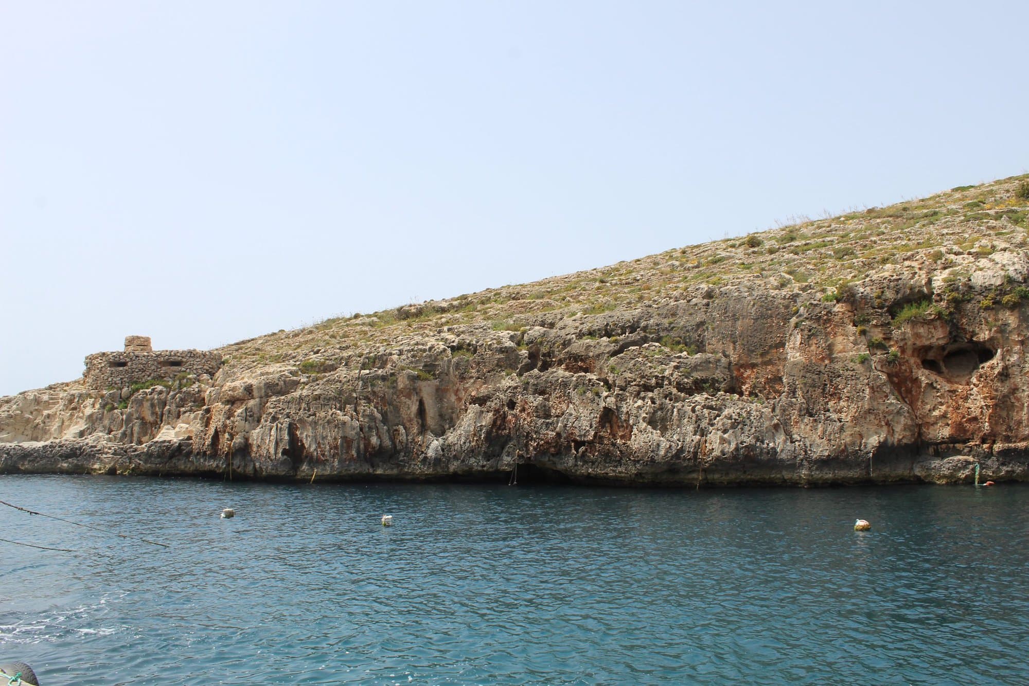 water with a rocky outcrop above it