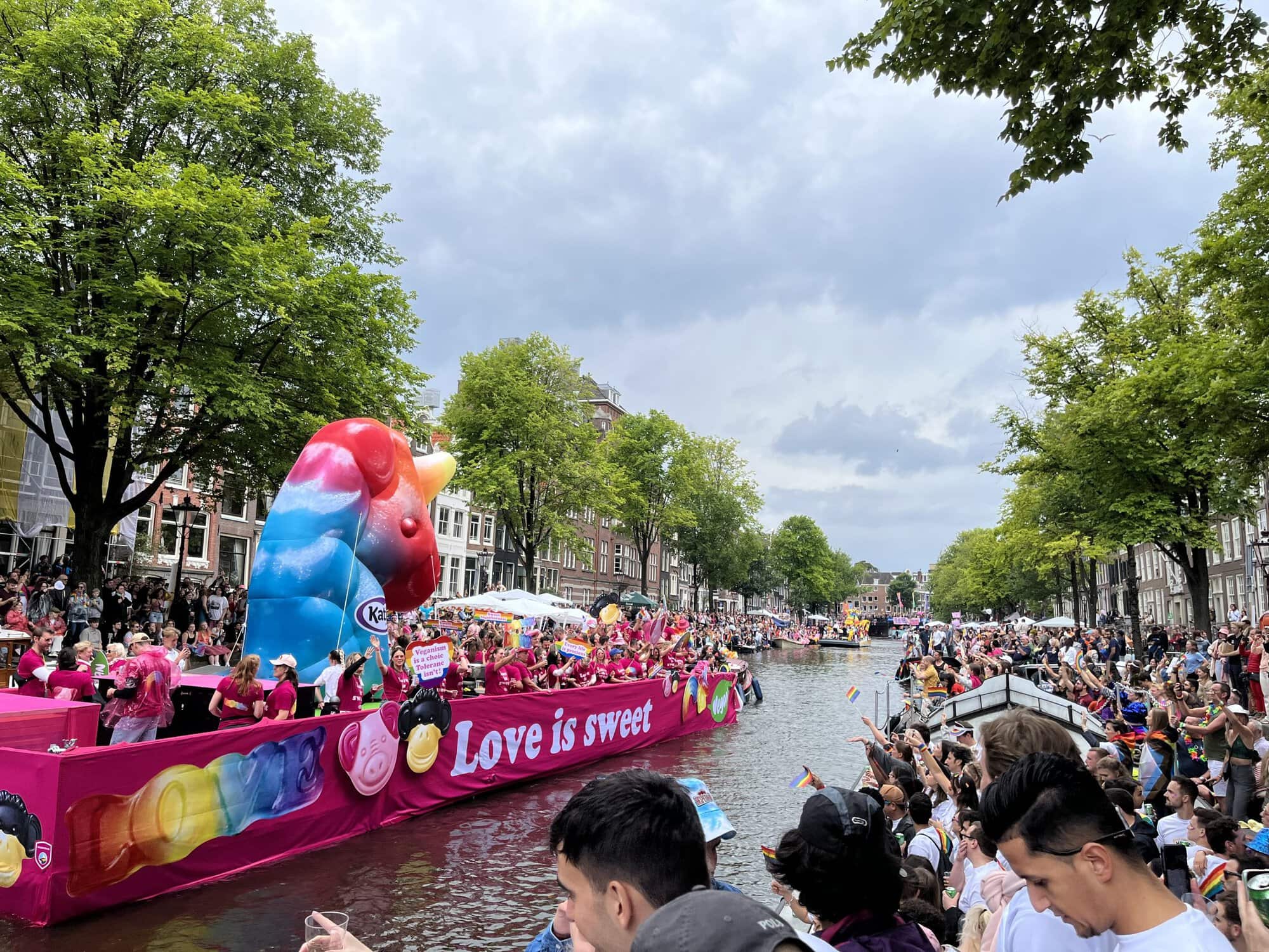 floats and people lining the streets at Amsterdam Pride Parade