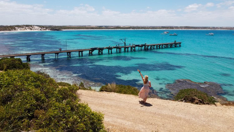 see the electric blue waters with a pier at Vivonne Bay Kangaroo Island
