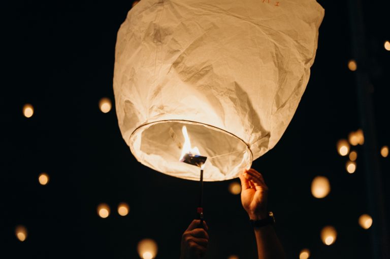 a lantern being released into the sky at night