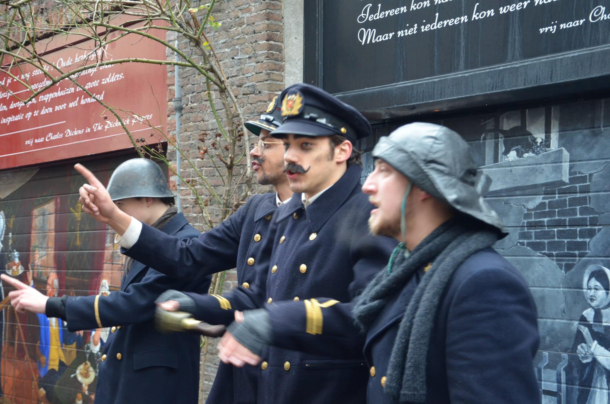 actors dressed as policemen in street performing at the Dickens Festival