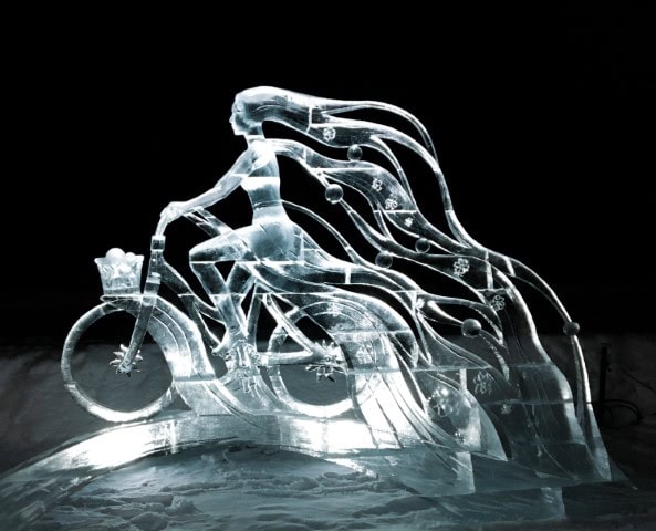 ice sculpture of lady riding a bike with hair flowing at back