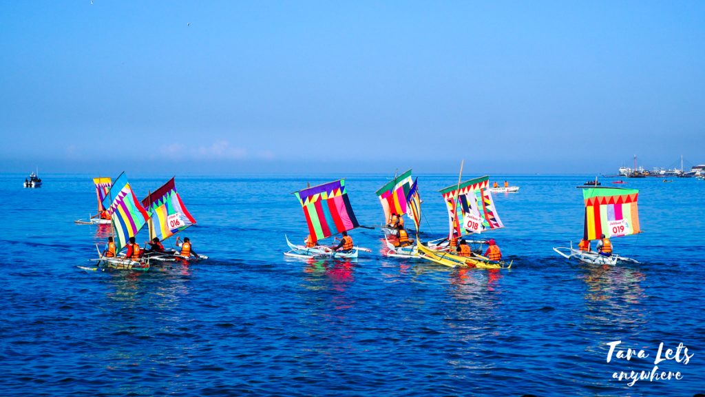 boat with colourful sails in the water off the coast in the philippines