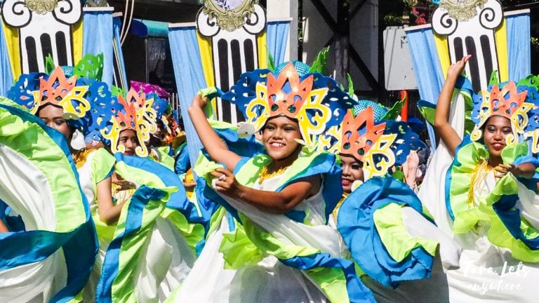 dancers in the street dressed in colourful clothes at October Festival in Zamboanga