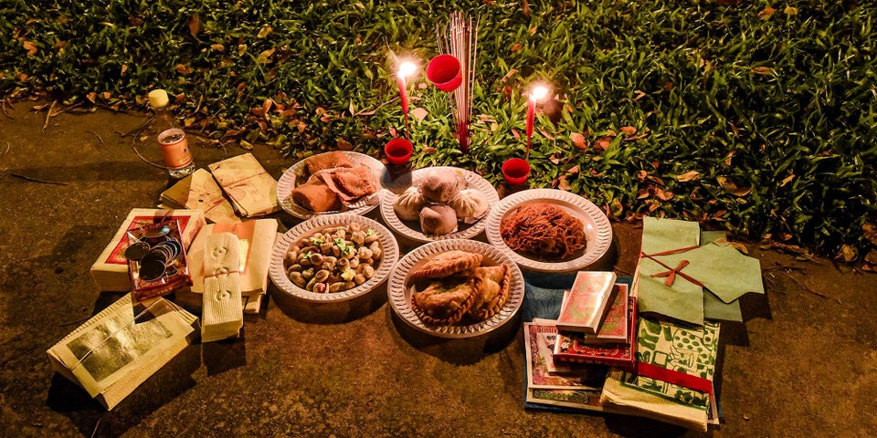 Offerings of food, incense and paper money for the Ghosts at the Hungry Ghost Festival