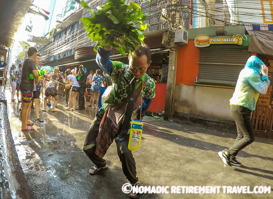 a thai man dancing in the street during songkran