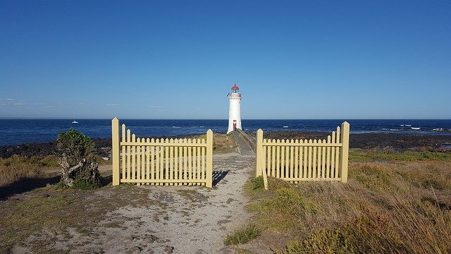 fence in front of Port Fairy Lighthouse on the water