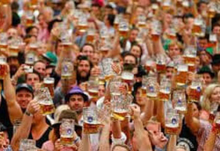 large crowd with glasses of beer raised in the air at Prague Beer Festival in march in Czech Republic