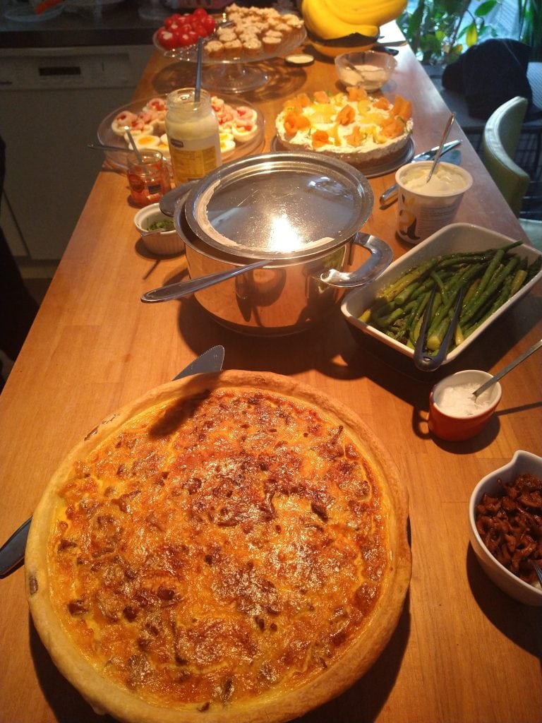 a table of swedish food dishes at midsommar