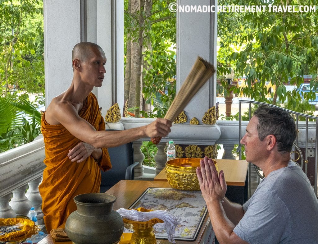 a buddhist monk blessing a man