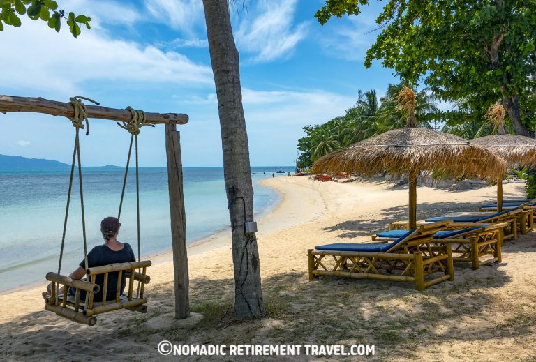 lady sitting on a swing seat overlooking the beach