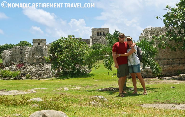 a couple standing in front of ruins in tulum