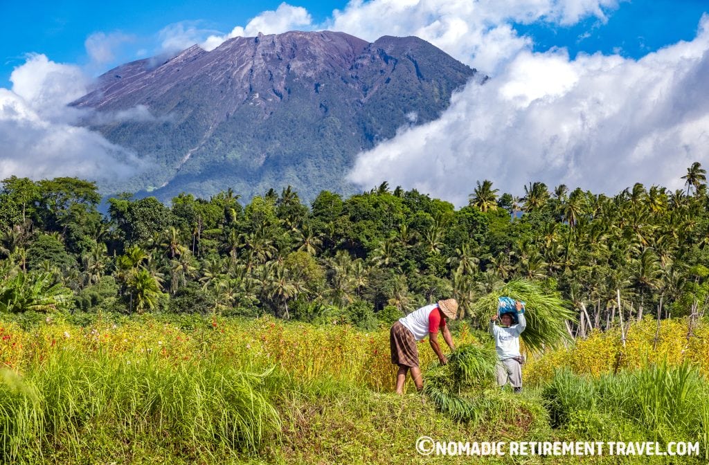 farmers working in front of a volcano in bali