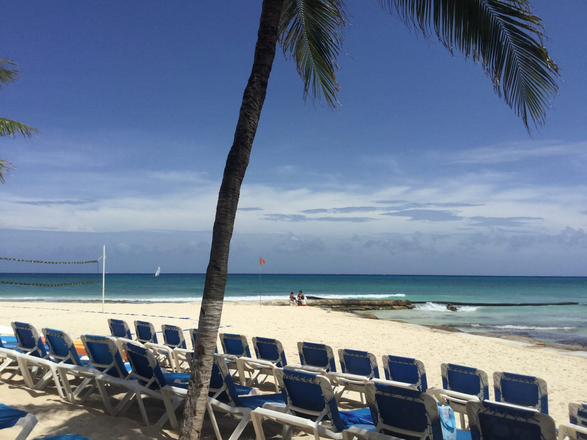 The white sand beaches of Playa Del Carmen with chairs in foregound