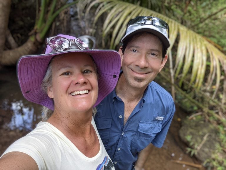 a couple looking into the camera smiling
