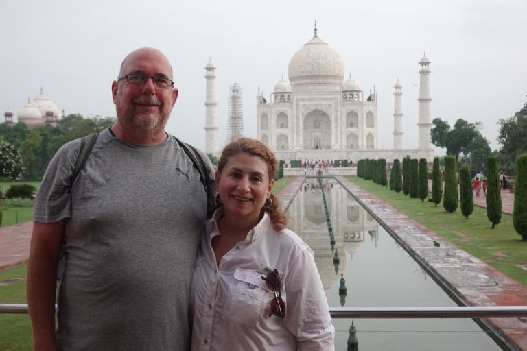 a couple standing in front of the taj mahal