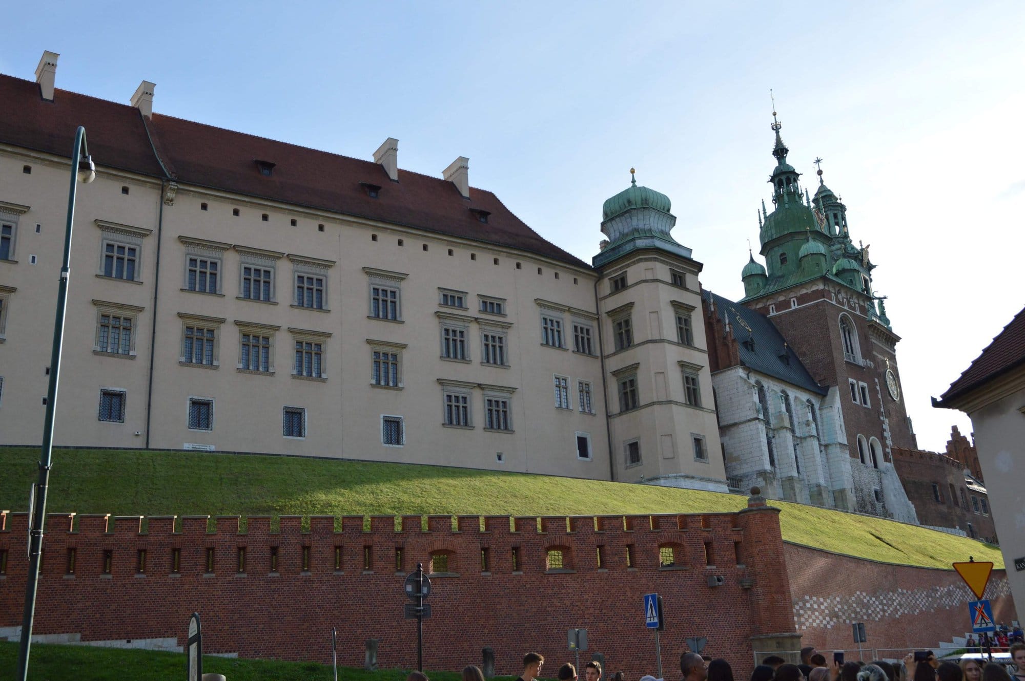 red and cream castle on a hill in krakow