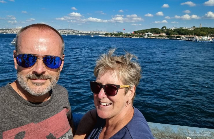 a couple with the sea in the background