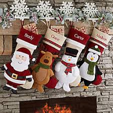 christmas stockings hung on a mantle over a fireplace