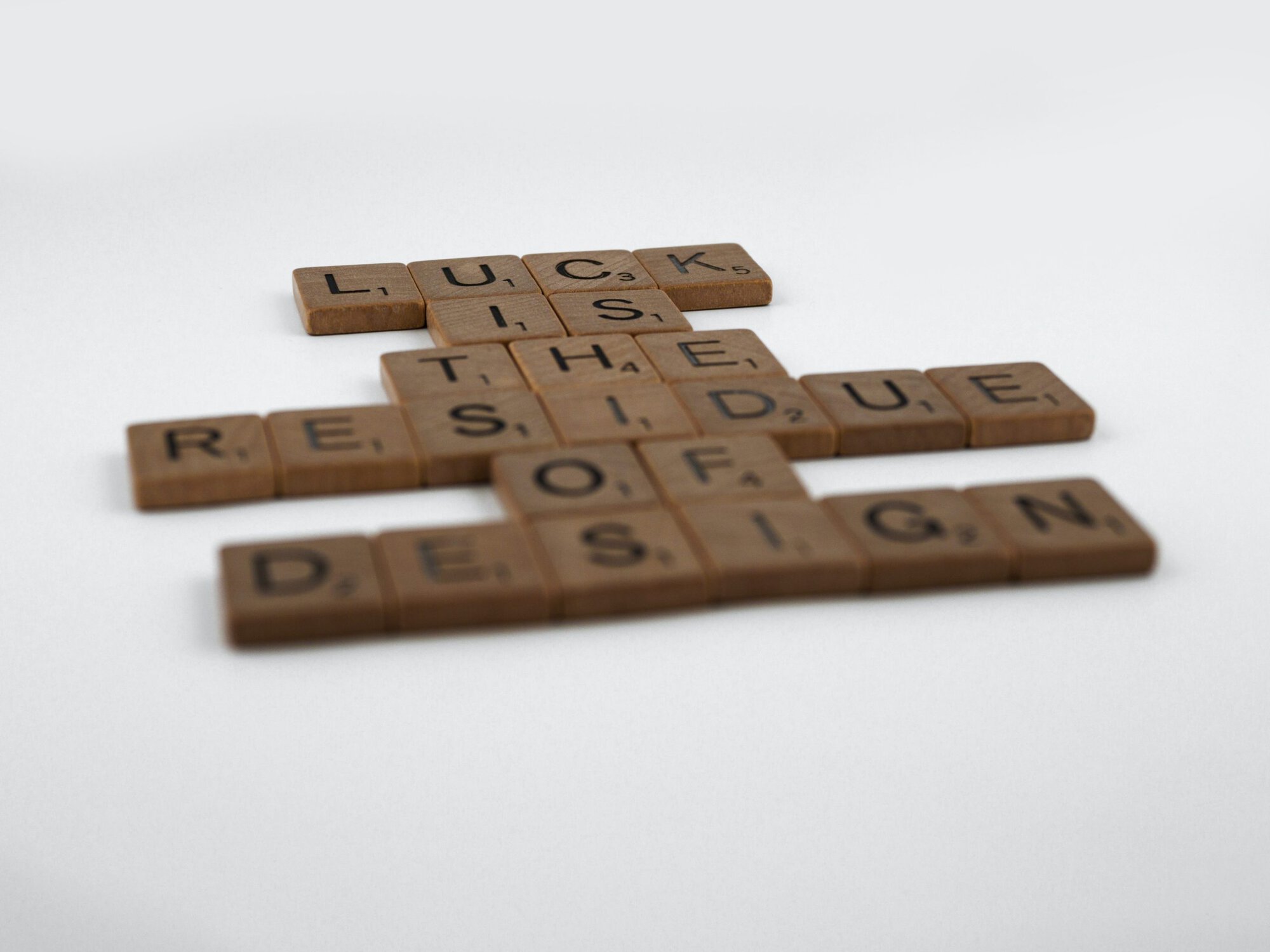 scrabble tiles saying 'luck is the residue of design'