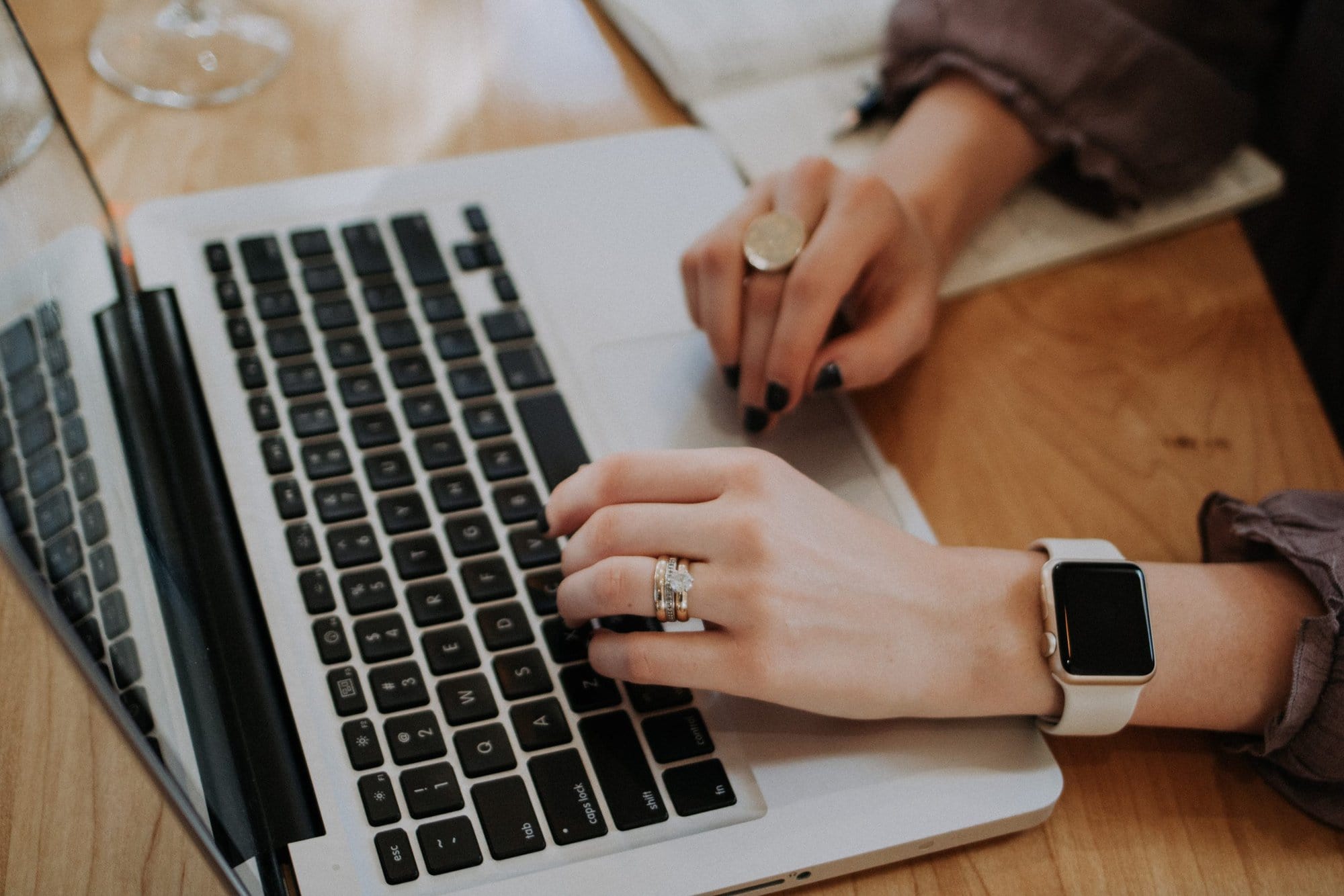 a lady typing on a laptop