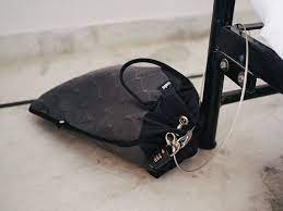 Pacsafe Portable Travel Safe - attached to the leg of a desk
