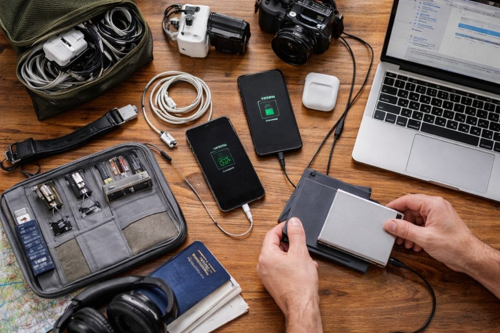 Cables, tech gear, and backup drives being checked before a long trip
