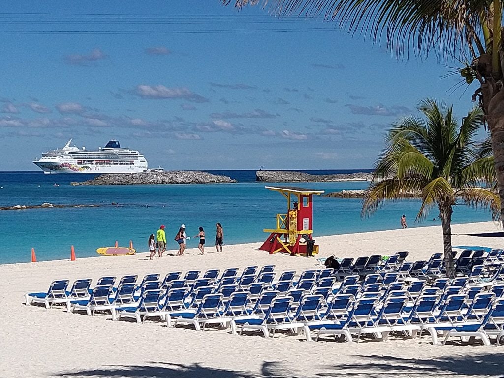 Beach scene in the Bahamas with cruise ship during long-term travel itinerary planning