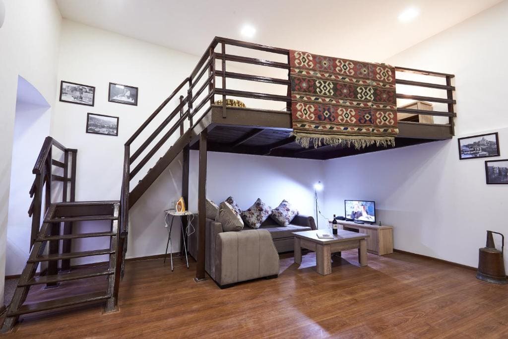 Loft-style apartment in Tbilisi showing affordable long-term travel accommodation setup
