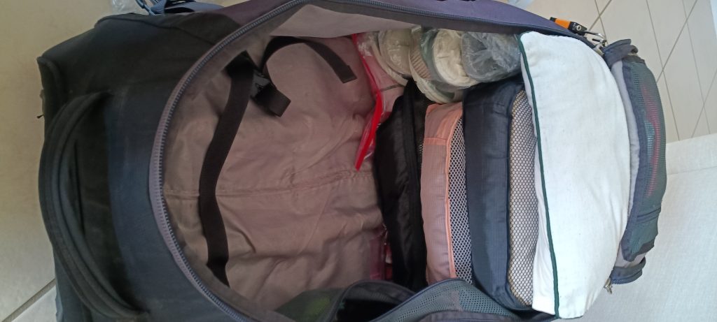 Suitcase packed with cubes and organised gear ready for long term travel