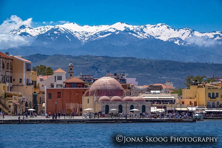 Old Town Chania harbour in Crete, Greece in May with sea and mountains, part of best countries to visit by month