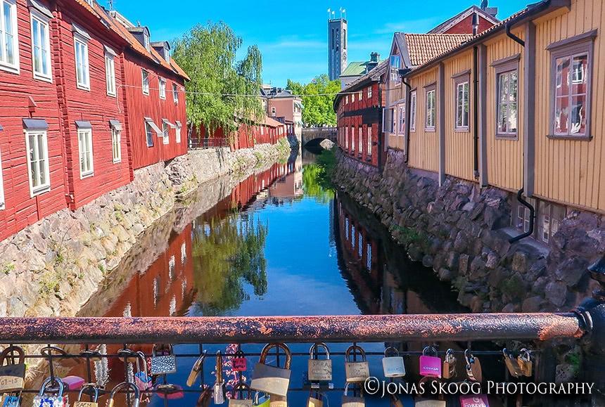 River lined with colourful wooden houses in Vasteras, Sweden in July, featured in best countries to visit by month