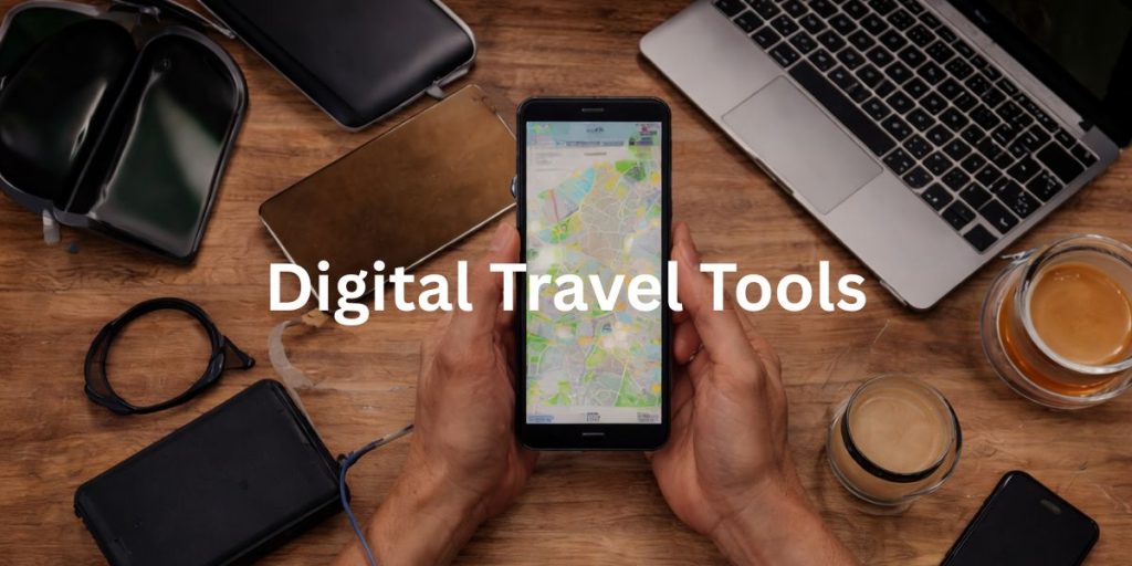 Digital travel tools setup with laptop, smartphone, camera and maps for planning a long-term trip