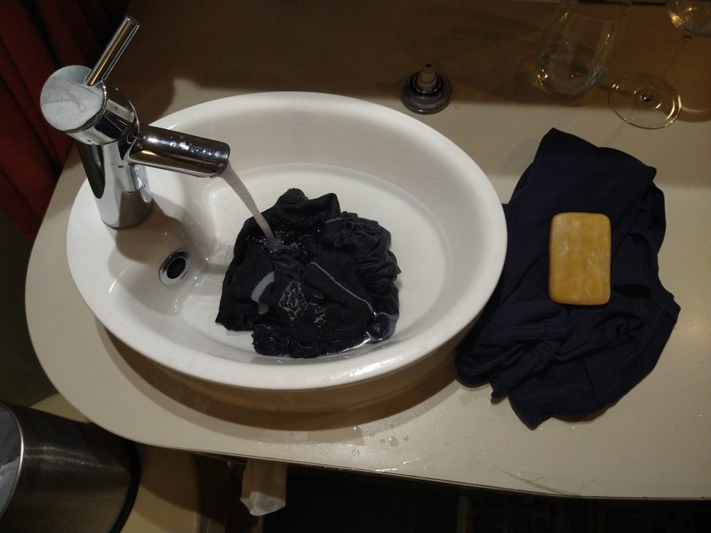 Washing clothes in a sink while travelling showing the everyday reality of full-time travel
