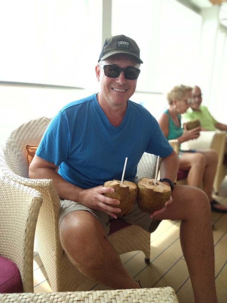 Drinking fresh coconuts on a cruise showing enjoyable moments during full-time travel lifestyle