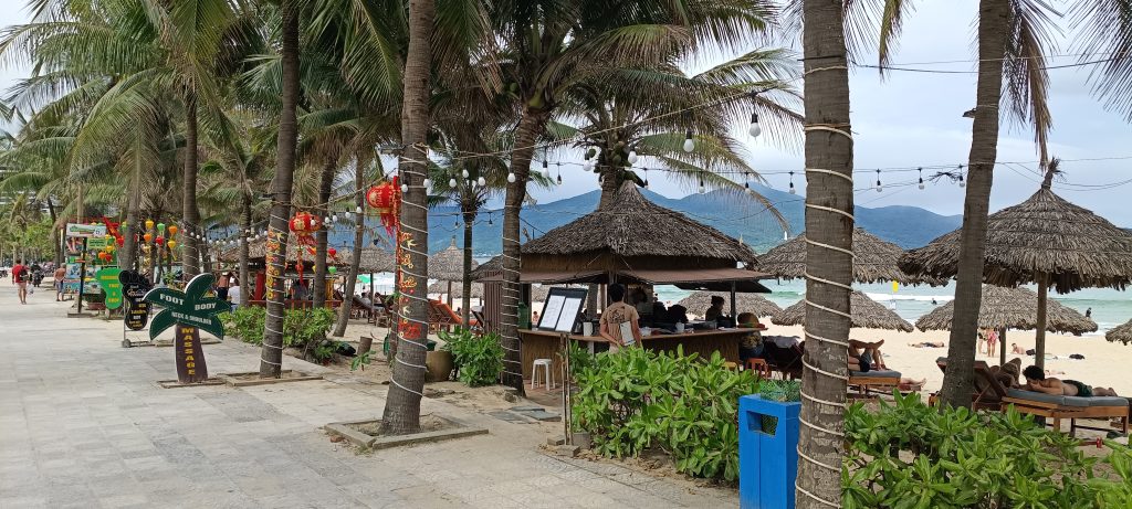 Da Nang beach promenade with palm trees and cafes, a popular slow travel destination in Vietnam